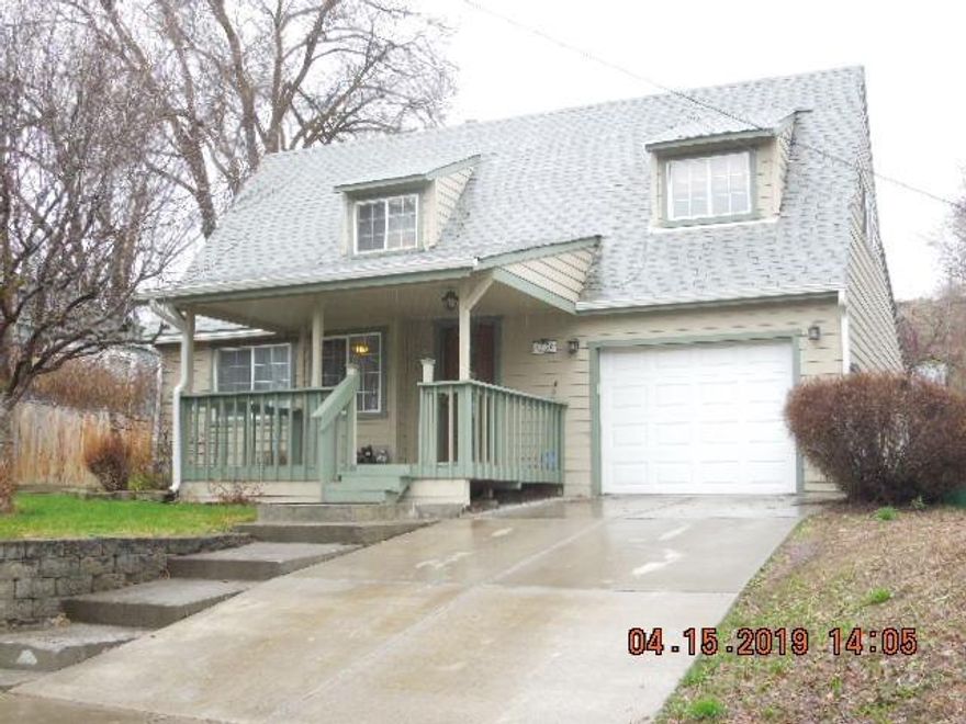 Beautifully updated 4 bedroom, 2.5 bath home! Large living room with newer laminate flooring through out. The kitchen cabinetry has been refinished, granite tile counters, newer appliances, huge walk in pantry. Kitchen is open to the dining room which leads to the back patio, landscaped terraced yard, also fenced with gated access on the side of home. The master is on the main level with access to the patio as well. The bathroom is updated with a double sink vanity, tile walk in shower, and tile floors. Upstairs is a second bathroom also updated and situated between 2 lrg bedrooms. Single car garage, with adorable front porch, plus a basement great for additional storage. New carpet scheduled for installation. This home is move in ready!