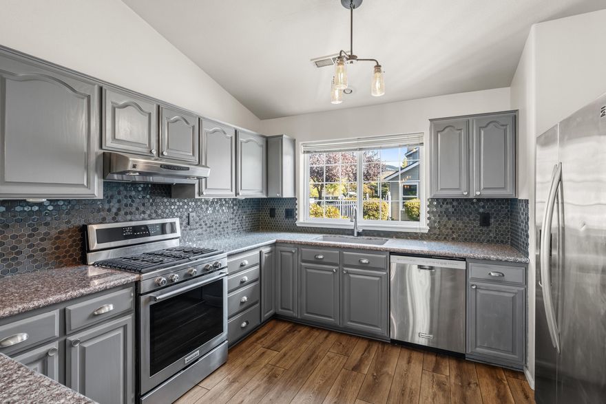 Move-in ready and freshly updated! This 3 bed, 2 bath townhome offers 1,435 sq ft of easy living in a fantastic  East Medford location. The main level features an open kitchen, dining, and living area with a cozy fireplace and brand-new flooring throughout. The downstairs primary suite includes an ensuite bath, while upstairs you'll find two more bedrooms and a shared bathroom. Enjoy peaceful views of the green space from your covered deck—no neighbors right behind you! The HOA keeps life simple, covering water, sewer, exterior maintenance, landscaping, clubhouse, and pool. Single-car garage for added convenience. Hassle-free living in a well-kept community close to shopping, restaurants, and everything the Rogue Valley has to offer!