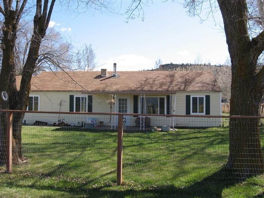 This property deserves a close look, it has three wells, one for irrigation, one for house and the third for the large shop. The large shop includes a separate living quarters. There is a second shop with power for woodworking and a chicken coop. The covered wood storage area can hold up to 7 cords of wood. The house has vinyl siding and double pane windows.
