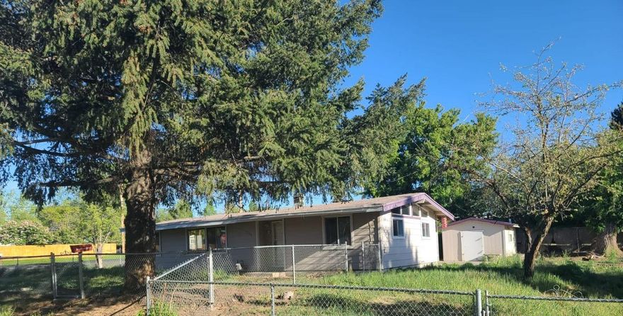 Attention investors or first time home buyers. This sweet fixer upper has 2 bedrooms, 1 bath located on a large .23 lot is ready for your finishing touches. Open concept floor plan with high vaulted ceilings throughout. Roof done in 2013. Great big fenced yard with a large attached storage building and a smaller detached shed. With a little work you can have yourself a pretty nice property. Call for a showing today!