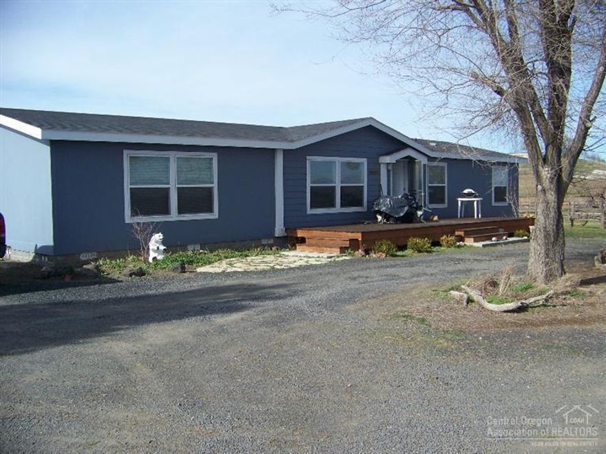 Perfect opportunity for country living close to town. Home is landscaped and spacious. Also included is a nice detached garage and 2300 plus square foot shop barn. Home sits back off the highway and is quiet and private. Lots of room and set up for your horses, cows etc. Irrigation equipment is included with the sale. Additional property can also be purchased if a buyer would like more ground.