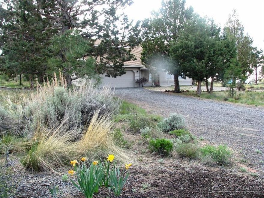 Irresistible 3 bedroom situated on 2+ acres with paved road, close to open land. Includes RV parking garage, garden shed, attached garage, spot for water feature near back deck. Dramatic 2-story living area is light & bright with stylish windows & hardwood flooring. Kitchen has solid surface counter-tops, adjoining nook plus formal dining area. Master includes walk-in closet, adjoining bath, private balcony w/ mountain views. Detached large RV garage/shop w/ double carport gives plenty of storage.