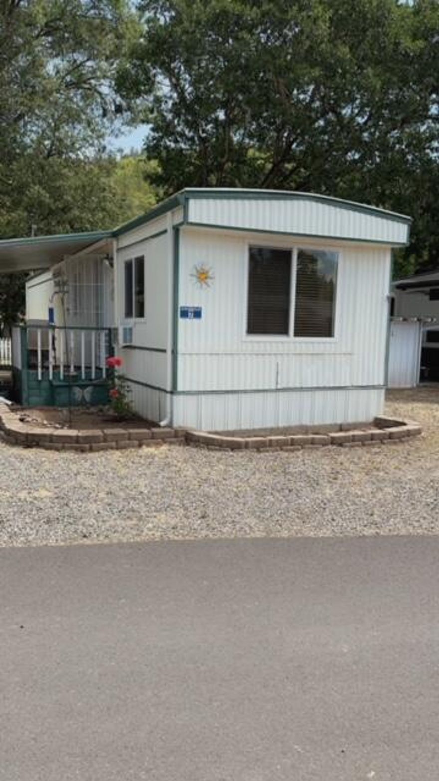 Discover your cozy retreat in our welcoming 55+ community! This charming single wide mobile home has been lovingly updated and is ready for you to move in. The heart of the home is the beautifully renovated kitchen, featuring ample cabinets, marbled countertops, and a modern glass top stove. It's a space where you can truly enjoy cooking and entertaining. The bathroom has been fully modernized, showcasing a stylish tile shower that brings a touch of luxury to your daily routine. The windows feature vinyl frames and elegant faux wood blinds. Accessibility is a key feature, with a sturdy ramp at the front making entry easy and safe. Additionally, the property includes the largest shed/workshop in the community - perfect for your hobbies or extra storage and a white picket fenced back yard. Included with the home are a refrigerator, washer, dryer, and oven, ensuring you have everything you need from day one. Come see this delightful home for yourself.