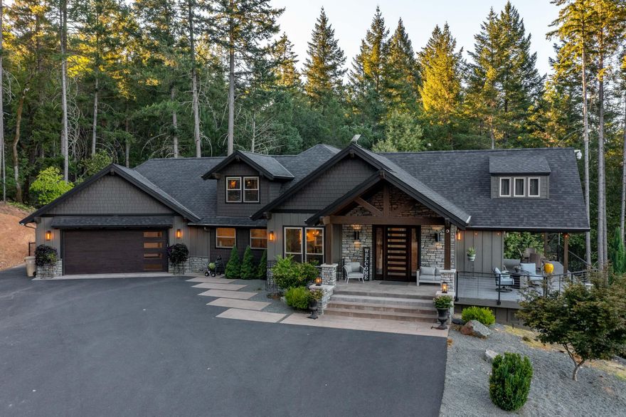 Mountain Lodge Retreat!! Custom Home is app 3157 sq ft, 4 bed, 4.5 baths, with additional Studio D/S of app 390 sq ft for visitors or family. Perched perfectly on 3.43 acres overlooking the valley, hills, and the city in the distance. Upon entry, greeted with soaring vaulted L/R, gas fireplace, expansive windows that allow for stunning views, natural light, and access to the open beam covered porch. Primary ensuite, is vaulted as well, with its own gas f/p & side porch. Main bath offers heated tile flooring, curb less oversized shower, soaker tub, spacious walk in closet, and water closet. Expansive kitchen is equipped with high end appliances designed for both serious cooking and entertaining. The loft hosts a 2nd ensuite, and seating area. The main floor also offers a spacious dining room, 2 b/r full guest bath, 1/2 bath for guests, and large laundry room. There is  interior & exterior access to the fully equipped guest studio quarters below. Property is fenced, with lush back lawn.
