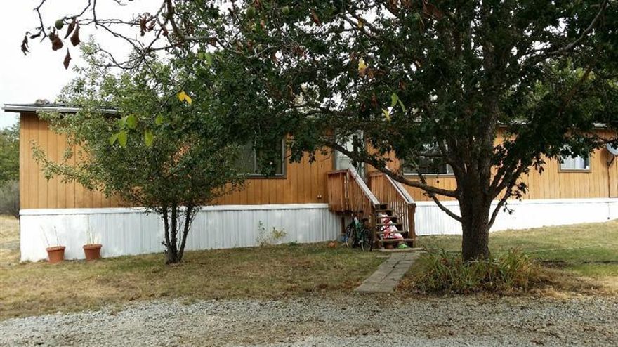 4.60 level acres with a 1984 doublewide manufactured home. Great place to call home. Plant a garden, enjoy spacious home with split floorplan and inside laundry. New electrical power pole.