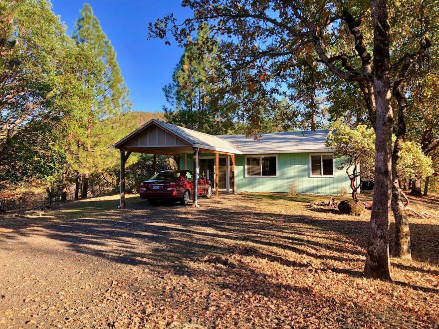 Cute and cozy home in Shady Coves desirable neighborhood of Rene Drive. Beautiful, mature oak trees and nice views of the mountains, makes this over 2 acres property a special place to live. The home and property have been well cared for. The floor plan is very open and makes good use of the space so it seems larger than it is. The bedroom is good size and the bathroom also has a washer and dryer. There is a carport and room for RVs. The Rogue River is nearby and that is the perfect place for fishing or rafting. There is lots of wildlife in the area so you will most likely see a deer walk by as you are drinking your morning coffee on the patio. - Per the City of Shady Cove, the property may be dividable. Don't miss the opportunity.
