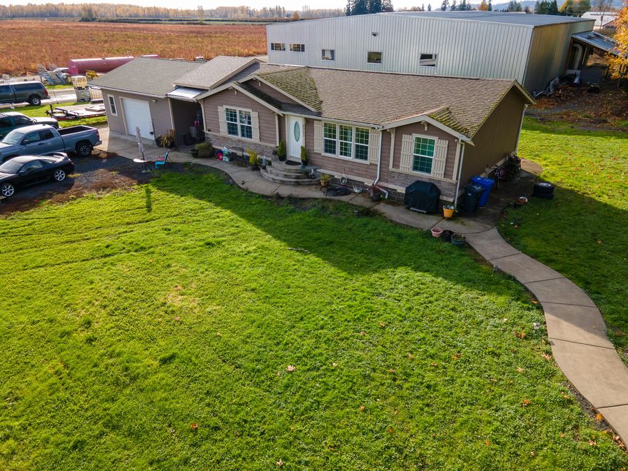 This versatile property has a newer 9,600 SqFt shop, the majority of which is insulated and cooled with a 2-15 ton refrigeration system that is supplied with a 200 amp service. This modern shop has a 20' x 24' finished office and ground level break room. Currently used as a blueberry cold pack plant on one side and a flex space/mechanics area on the other side. The well built 1,344 SqFt manufactured home has an attached garage and features 3 bedrooms and 2 bathrooms.