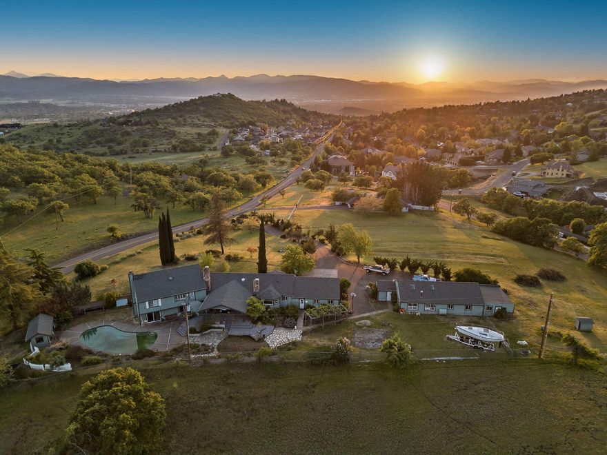 Welcome to an incredible opportunity! This spacious 4,812 SF multilevel home sits on 3.08 acres, surveyed and approved to subdivide into six half-acre lots, offering outstanding investment potential. Inside, you'll find 5 bedrooms, 3.5 bathrooms, 2 kitchens, 2 living rooms, 2 fireplaces, granite countertops, a double oven, and abundant storage. The lower level can easily become separate living quarters. Relax on the covered deck, host BBQs by the in-ground pool, or enjoy the bright art studio filled with natural light. With stunning valley views, sunsets, city lights, and plenty of guest parking, this property is perfect for making cherished memories. Plus, with newly built homes nearby, the development potential is as promising as the memories you'll create here. Whether you're looking for a dream home, a multi-family retreat, or a savvy investment, this property delivers endless options and incredible value. Don't miss this one-of-a-kind home!