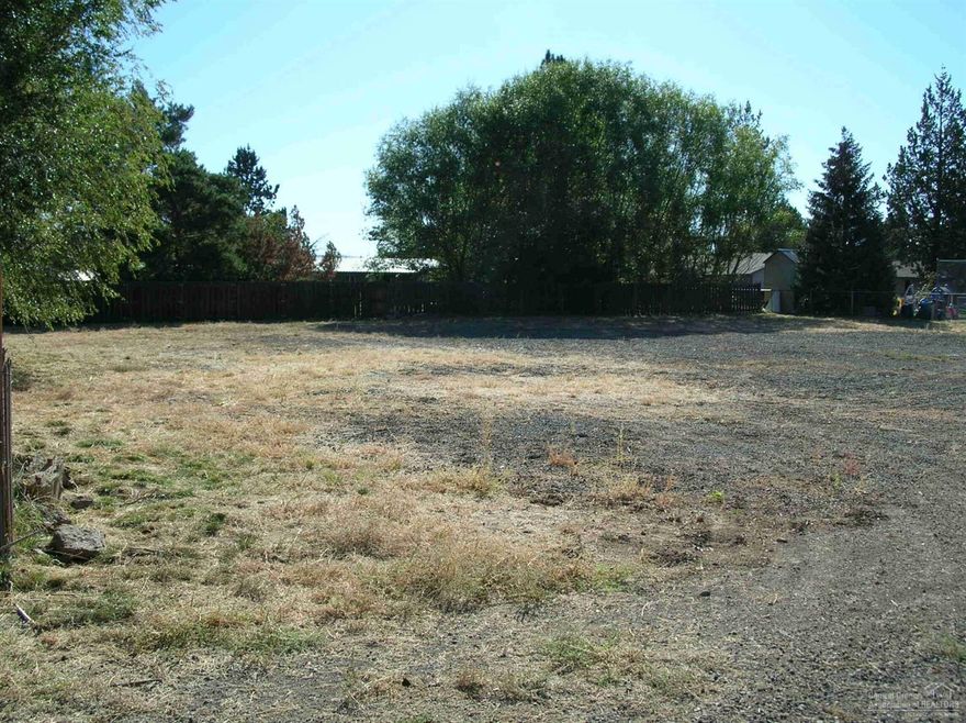 Hard to find flat lot, approx. 1/4 acre in quiet established neighborhood. Borders canal. Sewer is stubbed to property. water to left in road at Pumice. Power at corner of Pumice and 27th Place. Co-owner is licensed real estate broker in Oregon. Adjacent lot for sale.