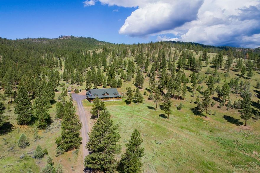 Set among the pines, this custom home sits on 200 acres of forested timberland. Enjoy valley views from the wrap-around porch, ride a horse among the junipers or hop atop a quad in search of elk, turkey or other wildlife. Spacious home throughout with 5 bedrooms, 4 baths, 4088sqft. and an oversized 3 car garage. Step outside to discover a barn ideal for storage and livestock. This private location borders the Ochoco National Forest, but remains 10 mins. to the Ochoco Reservoir and another 10 mins. to town.