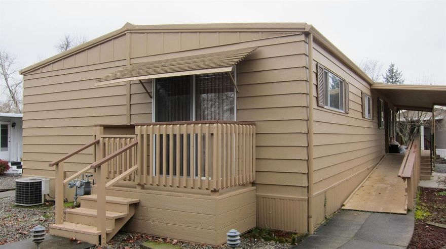 Priced to sell! Upgrades in 2016 included new carpet throughout, new gas stove, exterior painting. Large Master Suite & bath. Sun room off the back is enclosed (plastic) and adds an 150 sq.ft of additional space. Shed pictured is not part of the sale. 55+ community, buyers must qualify with park (an easy process). In Rogue Lea Estates right on the Rogue River. Come join the fun just minutes from downtown historic Grants Pass, OR