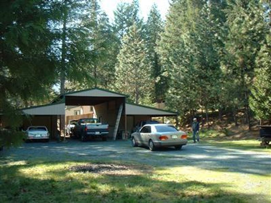 Wonderful tree-lined .85 acre parcel! Owner has standard septic app, homesite & house plans all approved by Jackson County. RV carport with sep shop & office with bath. All covered by attractive metal roof. 10 gpm well per owner.