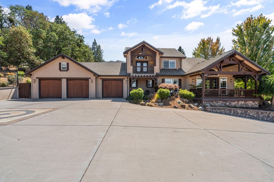 Just minutes from downtown Jacksonville, this custom Ray Williams-built home captures panoramic views from Roxy Ann to Mt. McLoughlin and the Table Rocks—vineyard-laced scenery that feels like a postcard. With 3 beds, 2.5 baths, and over 3,300 SF, you'll find flexible living.   Downstairs offers two bedrooms—one a mini suite with attached bath, the other ideal as a bedroom or office—plus an oversized flex room with a dry bar, wine fridge, and attached greenhouse room. Upstairs is a true primary retreat with private view balcony, spa-like bath, oversized closet.    Enjoy the thoughtfully landscaped yard with a custom Pagnini pergola, paid-off solar, public utilities, and rare dual garages: a 3-car attached plus a 2-bay RV barn/shop. All on 1 acre with room to breathe. Views, privacy, functionality—this one checks every box.