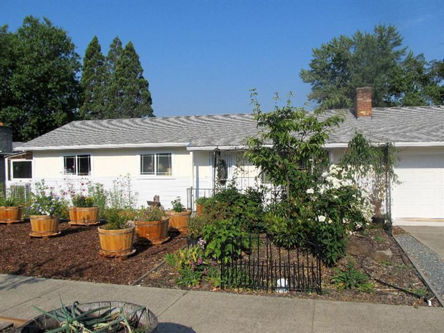 Country living? This feels like a fabulous home that is convenient in the city location, but has feel of a little country too. this home is totally renovated, from top to bottom, inside & out. New cabinets, all hickory, in kit and bath. New tile kit. and bath. Orig. Oak hardwood floors, totally refinished. New paint in/out.All new light fixtures. Window new dbl/pane, with Hickory sills. Plenty of light thru out home. One of bd, has access to a fiberglas enclosure, plant room, with spinkler for starting your own veg. plants, Plus a sep. 14 X 20 Glass greenhouse, & a 6 /x 20, grnhouse. Tiered water feature in back, with plants/fish. Privacy fencing along back of yard, where a very large area is located for a potential garden area,lawn,more parking, shop? Sep. l4 X 20 hobby room, multi use, exercise, game room,or crafts? RV parking avail. so many shrubs/plants, decorative items. No Time to waste, You must see to believe this home/prop.