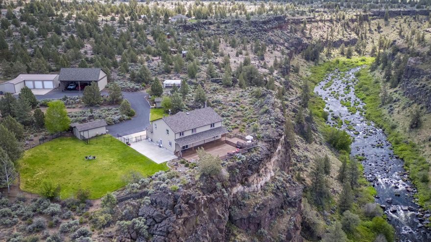 Beautiful fenced, gated 5 acre property on Deschutes River. This 5 bedroom home has a breathtaking river view from house and deck that creeps up to the canyon's edge. With a mountain view from the pasture to the sights and sounds of the river this is a spectacular property. Downstairs is balanced between open concept and private entertaining space.  Large kitchen boasts a peninsula and island, outstanding cabinet and pantry storage!  5 bedrooms upstairs are nicely spaced for privacy. The beautiful yard and natural rock formations create a peaceful setting.  Extra-large pole barn provides covered storage space for large toys.  Fully owned large solar array, provides the entire property with monthly electric bills of $15 for 8-10 months a year depending on winter usage. Enjoy the 3 bay garage, with shop and insulated tack room. Hay storage or horse barn, 3 sided shelter, 3 fenced pastures complete property for your animals. At 2.4 miles to NW Lower Bridge Way it's a quick trip anywhere!