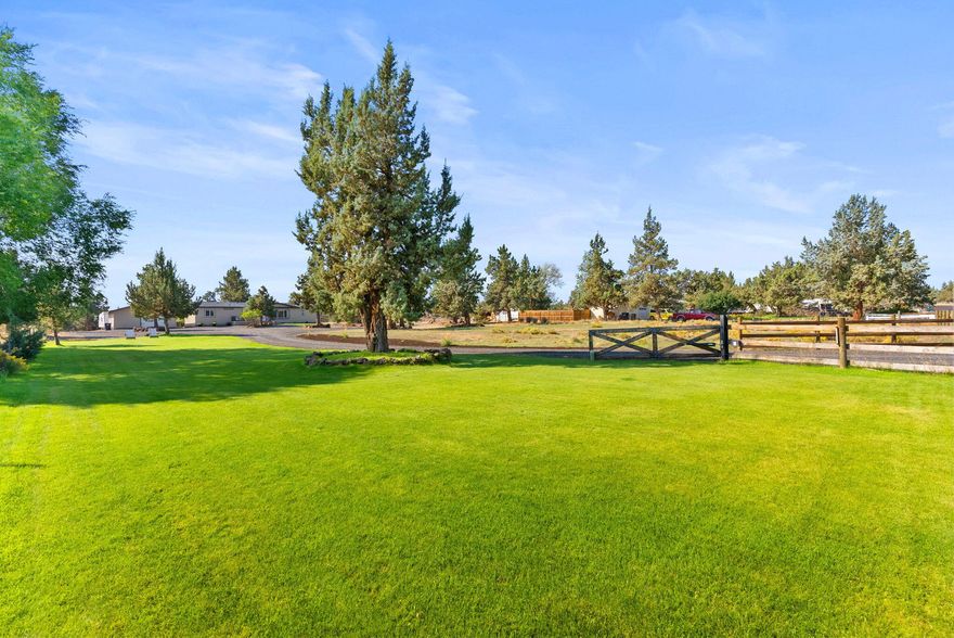 Move-in-ready home on nearly 2.5 acres with 3 bedrooms plus a den/office that can function as a 4th bedroom. Bright interior with updated kitchen, stainless appliances, farmhouse sink, walk-in pantry, and LVP flooring throughout much of the home. Separate living and family rooms offer space to spread out. The primary suite includes a walk-in closet and remodeled bath. The property is fully fenced and cross fenced for animals ,with a loafing shed for animals, equipment shed, storage shed, and an oversized 760 sq ft garage. Outdoor updates include a front porch with iron railing, paver patio with awning, pond, raised garden beds, and RV parking. BLM land is nearby for added outdoor adventure. Private, gated, peaceful setting set back from the road—ideal for a hobby farm, gardener's, or simply enjoying space to breathe.