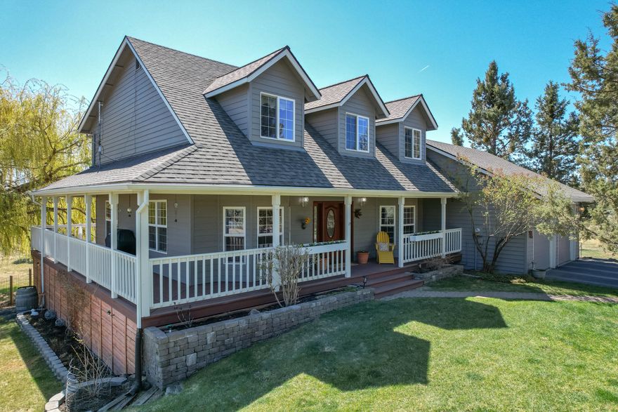 Private and tucked away, this special Bend property provides the space and quiet of country living, while being conveniently located to the amenities of the city. This 2126 sqft ''farmhouse'' style home has recently been updated. Featuring a wraparound porch, 3 bedrooms, 2.5 baths and a 1008 sqft daylight basement. Kitchen updated in 2015 is a chef's dream. Great room centers around a cozy gas fireplace and front room that could be a perfect home office. Large mud room and attached 2 car garage with workbench area. Fully fenced 5.63 acres, 3 acres of Swalley irrigation, 20'x30' enclosed barn with 110 power, lined creek, pond, loafing shed, and 6-station underground irrigation system. E2 Solar with 14 panels on the east side of roof provides electricity for house and irrigation. Greenhouse, fenced garden with 5 raised garden beds, hot tub,3 fruit trees and natural lush landscaping. View of Pilot Butte from back deck to gather and watch 4th of July fireworks! Don't miss this one!