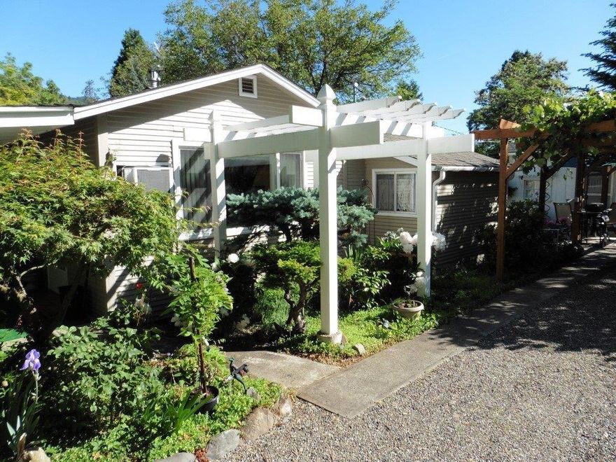 Hard to find, LOW Bank frontage on the World Famous Rogue River. Pride of Ownership Cottage with Guest Qtrs. on a private, level and beautifully landscaped 2.93 acres. Live in the Cottage while you build your dream river home or create memories as a vacation destination for your family. Detached 3 car garage, separate shop for your hobbies & abundant room for RV parking for those family BBQ's & re-unions. Enjoy the cottage that has been updated, with covered porch surrounded by shade & fruit & walnut trees & large grape arbor. Over 140 feet of river front with beach access for fishing the famous Rogue Salmon & Steelhead runs.. No license Required on your own property. Includes Apple, Plum, Pear & Fuyu persimmons. Short distance to shopping, mountain lake fishing & camping, winter skiing & only 1.5 hours to the Pacific Ocean. You will want to keep this Hidden Jewel in the family for generations. New septic installed in 2011. All information deemed accurate but subject to change.