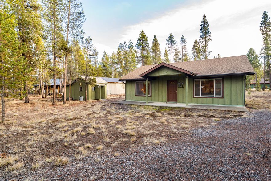 Discover the perfect cabin getaway in the heart of Central Oregon! This fully furnished 2bedroom and 1 bath home in Sun Country Estates offers a peaceful retreat with all the amenities for comfortable living. Inside, the open-concept design features a cozy living area with vaulted ceilings, a wood-burning stove and open to the kitchen with plenty of storage.  Set on a level on acre lot, the outdoor space is ready for your vision. Bunkhouse for extra guest or storage. 24 by 30 shop ready for all your projects.  Ideally located just minutes from the Big Deschutes River, this property invites you to enjoy kayaking, skiing, fishing, or quiet riverside strolls. Experience the charm of cabin living while being close to all the outdoor recreation and amenities that Central Oregon has to offer.