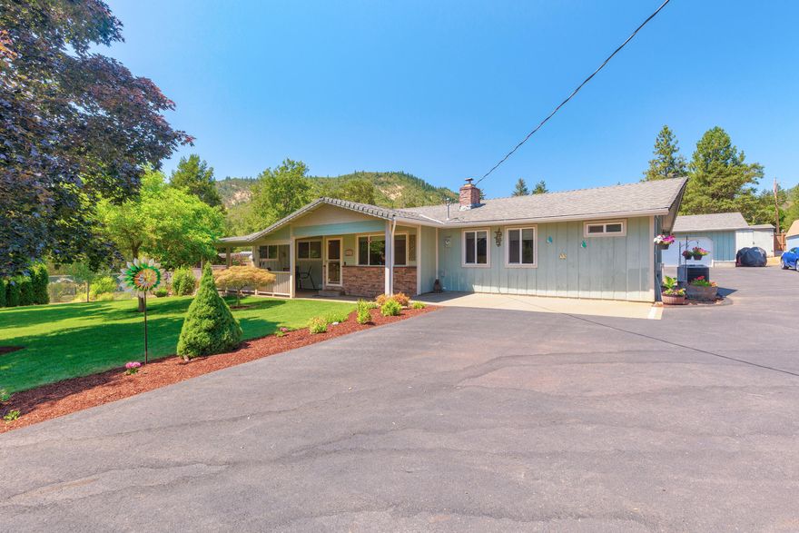 Room for Your RV, Garden, and Guests! Tucked in a quiet, rural setting with mountain views, this 3 bed, 3 bath home on just over an acre blends open space, function, and comfort. With a dedicated office and two primary suites, it is ideal for hosting guests or multigenerational living. The kitchen features granite counters, a large island, double ovens, and a new dishwasher-perfect for everyday meals or entertaining. Enjoy cozy evenings by the fireplace and summer days outside with your covered patio and gazebo. The property is fully fenced and cross-fenced, with beautiful landscaping, a drip system, and plenty of room to garden or play. A detached 2-car garage with workspace, 3 storage sheds, and dedicated RV parking means room for everything. Newer heat pump, electrical panel, fence, driveway, manual gate on Tracy, and automatic remote gate all add peace of mind. On well and septic, with a sense of space and self-sufficiency, this home is ready for your next chapter.