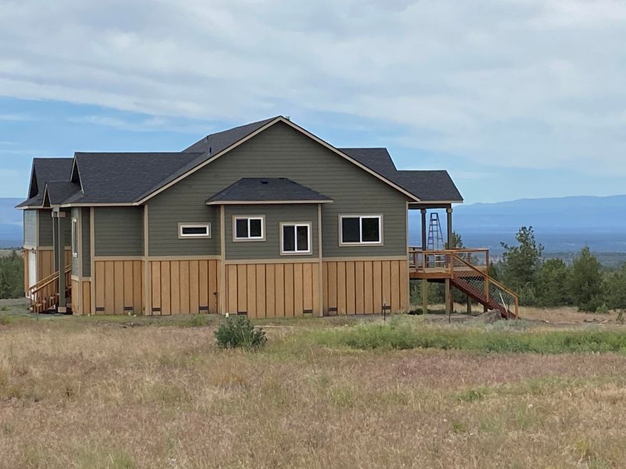 Final stages of this new home near complete. Beautiful 10 acre setting to see Cascade views. Quiet area with little traffic on road. Approx 7 miles from Prineville. 2744 SF home with all the quality finishes. Great room has T&G pine vaulted ceiling with certified wood stove. Kitchen with gas cooktop and oven. There's also a 2nd oven and microwave. Refrigerator, dishwasher, and disposal. All granite counter tops in kitchen, island and bathrooms. Central vaccum system and on demand propane water heater. Outdoor access to wrapped porch from kitchen, great room and master suite. Owner builder has done quality work and ready to call this project complete. If you're looking for quiet, exqusite views in estate home, this is it.