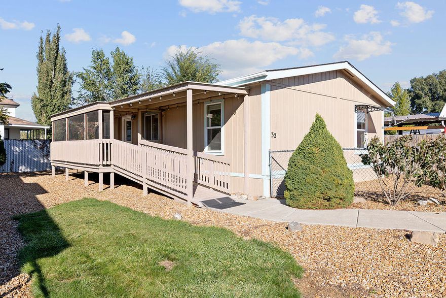 Spacious 3 bed, 2 bath manufactured home located in 55+ park. This well maintained home features a large covered deck with ramp access, perfect for relaxing or entertaining and a fenced yard for added privacy and pet security. Inside is bright and open with vaulted ceilings and many updates including a tiled walk in shower in the primary bedroom, island with quartz countertops, new carpets, updated lighting, new vinyl plank flooring, and more! The property is equipped with a heat pump and split unit system, ensuring efficient heating and cooling year round. Situated in a friendly neighborhood, it is close to town amenities, shopping and services. The monthly space rent of $450 covers water, sewer, and garbage removal, making it an affordable and comfortable place to call home.