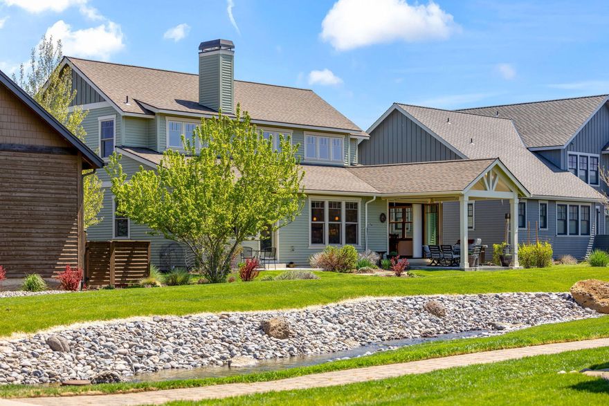 Custom home with three en-suites (two primaries) in Pine Meadow Village with Cascade Mountain and waterway views. Interior: High vaulted entry, Brazilian Acacia hardwood floors, large chef's kitchen with cherry cabinets, leathered granite counters, huge island, walk-in pantry, stainless appliances, propane fireplace with stacked rock, abundant light via double-hung windows with up/down blinds, panoramic sliders. Downstairs primary with patio access, views, walk-in tile shower, double vanity, private toilet, large walk-in closet with built-ins. Upstairs loft, second primary with similar finishes as lower primary, plus third en-suite, all with views. Large mudroom with sink, granite counters. Exterior: Covered patio with infrared heaters, extra-depth garage, HVAC with humidifier, recirculating hot water, freshly painted (Spring 2024), covered porch. PMV amenities: pool, jacuzzi, water features, walkways, close walk to town and forest trails.