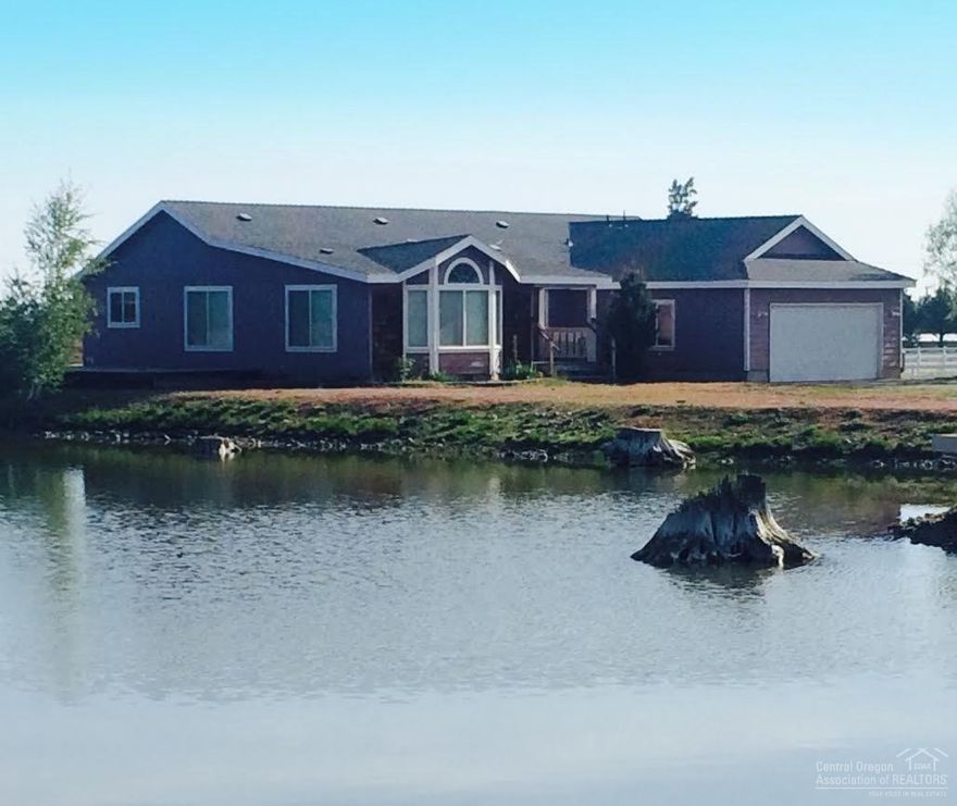 Newer 2005 manufactured home on 4.58 acres of land. 3 bedroom, 2 bath, office/den. 1807 square feet, double attached garage. Home site on a large pond which is shared with the neighboring property, beautiful setting. Home features vaulted ceilings, spacious master with walk in closet, kitchen island, double oven, kitchen sink overlooking the pond. Located in the desirable Sisters school district. Close to national forest land.