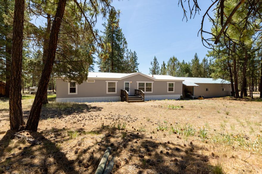 Come take a look at this...15.5 acres with a beautiful setting in the pines.  This 3 bedroom, 2 bath manufactured home was built in 2000 and offers a great open floor plan at 1848 square feet.  New Pellet Stove installed in 2018 and new laminate flooring and carpeting.  The homes exterior was painted in late 2020.  Metal roof was installed in 2019.  The garage/shop is 40'x24' and the property also offers multiple out buildings; Firewood storage, gardening shed, and a pole barn.