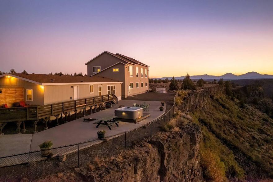 Best views in Central Oregon!! Situated on the rim of the Deschutes River Canyon, with panoramic and
unparalleled views from Mt Adams to Mt Bachelor, with the wild and scenic Deschutes River below, your
appreciation of Mother Nature will never waver. Besides the majestic view, this property offers elbow
room, at over 4 acres, and ample living space with over 3400 sq ft to call home. Perfectly setup for
multigenerational living or rental investment; a cozy 1620 sq ft manufactured home offering 3 Beds and
2 Baths, its own kitchen, expansive deck, hot tub and patio connects via interior breezeway to a 2nd
story living space with 2 Beds, 2 baths and a kitchenette. The upstairs living sits above an 1800 sq
ft, 4-bay garage, with one bay a dedicated workshop. Additional outbuildings offer more storage and
flexibility. Located in Crooked River Ranch, where recreation, community and vacation all call home.