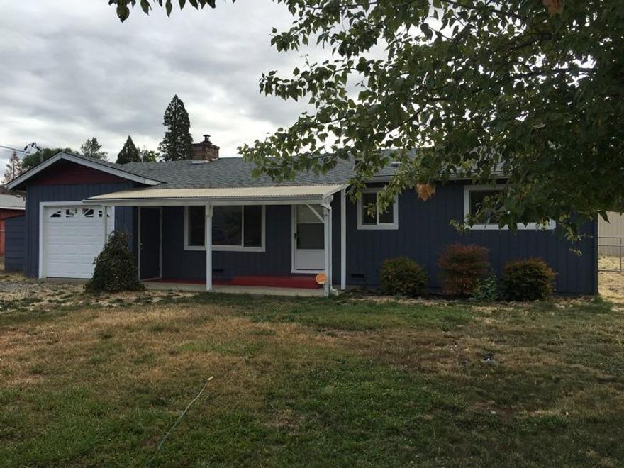 Don't miss out on this opportunity! This home is ready for new owners. Wonderful location near the hospital, fairgrounds, and Brookdale Grants Pass Village. Almost a 1/2 acre lot leaves plenty of room for a garden, animals, and much more. The home is a 2 Bdrm 1 Bath could easily be converted back to a 3 Bdrm (buyer to do due diligence)This is a must see!
