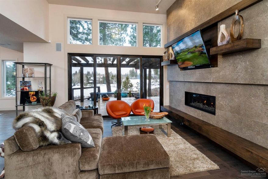 Fully updated single level home, perched above the 5th green with unparalleled views down the 6th Fairway. Every detail was carefully thought out and executed to perfection. From the moment you enter you will be captured by the stunning views from the open great room & dining room highlighted by artistic lighting. Fabulous chef's kitchen with European cabinetry, double ovens, 6 burner gas cooktop, 2-drawer Fisher Paykel dishwasher & mother-of-pearl backsplash. Spacious quartz island w/ bar sink & double-sided seating is the ideal setting for casual entertaining. Spacious master suite, also with beautiful views, is graced with a luxurious spa-like bath with heated floors & towel rack, soaking tub, beauty bar & dual closets. Master is nicely separated from the office & two en'suite guest rooms. Enjoy spectacular sunsets from the expansive decks overlooking the lake & fairways. Landscape maintenance provided by Broken Top HOA