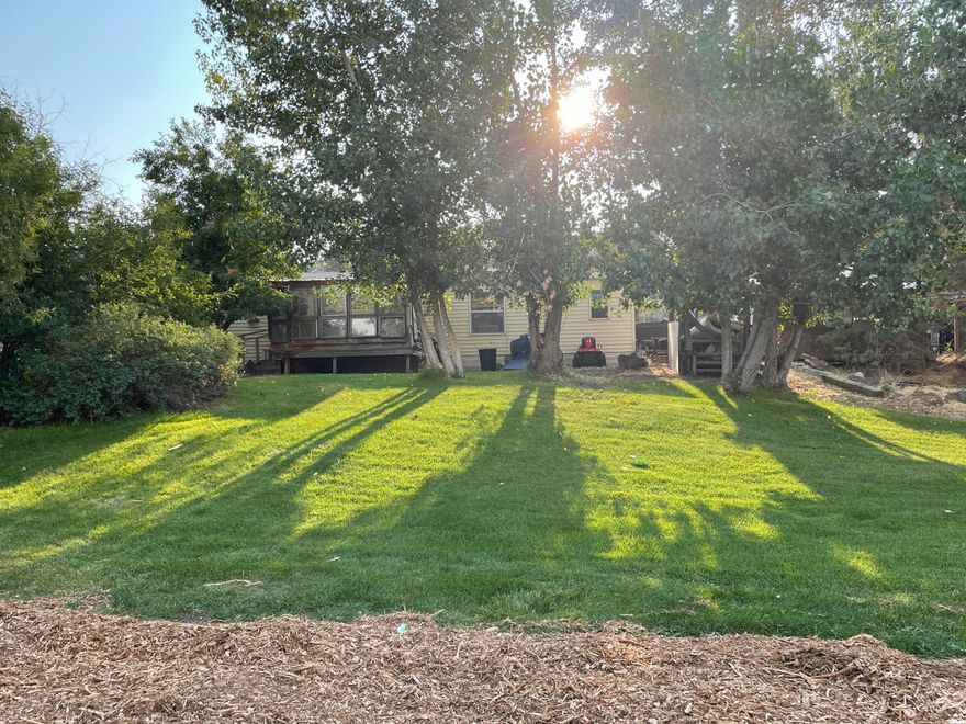 6.11 acres of land between Bend and Redmond for you to build your dream home or remodel the current home, tons of space to bring your animals!  Lots of storage outside with 3 sheds and a 31' x 23' work shop, perfect for wood working. Property goes up to 73rd street so you have two potential building sites. Home is 2 bedrooms and 2 bathrooms with newer roof and covered front porch. Front yard is landscaped with sprinklers and beautiful mature trees. Plenty of space for RV parking.