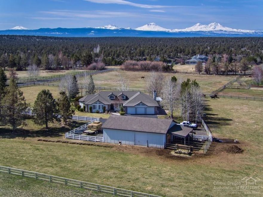 Wonderful home in the country on 4.8 acres between Redmond and Bend. Single Level home is 2476 sf, 3 bedroom, 2 bathroom, updated kitchen, living room, family room, formal dining room, decks, attached 3 car garage and landscaped with sprinkler system. Property includes: 4 acres of COI irrigation with pond for green pastures, livestock and is fenced. Barn/Shop is 1728 sf with 4 stalls, wash rack, office and shop area. Home is private on a quiet street with Cascade Mountain Views.