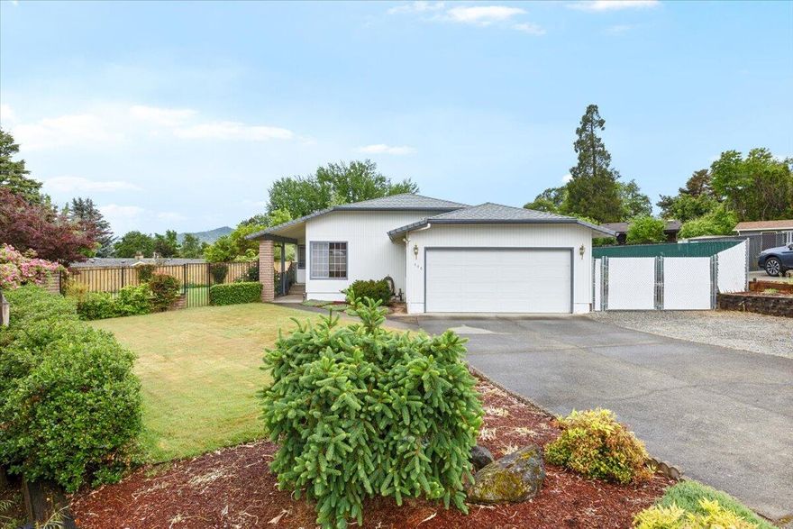 PRICE ADJUSTED - EXCELLENT OPPTY - Don't wait!!  Meticulously maintained and full of charm! This 3BD/2BA, 1,766 sf home sits on a generous .29-acre city lot with fenced back/side yards, happy roses, lush lawn and raised garden beds. A small orchard with apricot and fig trees enhances the serene outdoor setting. Wow!--there's RV parking with hookups, too! Inside, enjoy beautiful hardwood floors, granite kitchen counters, a garden window, and a spacious, inviting layout. The large primary suite offers a walk-in closet and retro bath with a separate shower room. The 2nd bedroom features two closets. Finished garage with storage, room for a freezer & more. Nestled in a neighborhood where pride of ownership shines. Relax on the covered patio or tend to the gardens. A special place to be and a true gem! Call today for a tour and ask for the Good-to-know list!