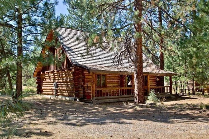 This authentic log home nestled in the Ponderosa Pines is the essence of living in Sisters! Hand hewn timbers and a river rock wood burning fireplace enhance this 1537 square foot hand scribed home. Cross the covered front porch and through the old schoolhouse door into yester-year. You will find wide plank wood floors throughout the great room with sun light coming in through the French doors and large upper windows. The master bedroom is on main floor with a private bathroom.  Second bathroom with jetted tub and shower. A generous loft serving as the guest bedroom, fine home office space or a workout room. This rustic log home sits on a large .64 acre natural lot, with room out back for RV parking or future outbuildings, garage or shop. This quiet neighborhood is perfect for sitting on the porch and deck to watch the deer wander through the pines. Tollgate amenities: paved bike/walking paths, pool, access to Forest Service.  Disconnected hookups for RV power, water and septic, as is.