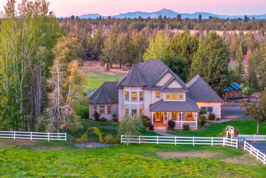 Welcome to Neff Estate, a stunning 20-acre farm where country serenity meets the convenience of nearby Bend. Set within irrigated fields, this estate features 12 acres of fertile land, perfect for harvesting orchard grass hay or supporting equestrian pursuits. A well-equipped barn, custom greenhouse, and multiple RV hookups ensure versatility, while a spacious shop and detached studio offer endless opportunities for work, hobbies, or business. The charming home features open living spaces, a cozy country kitchen, and a newly converted main-level primary bedroom with ensuite. Upstairs, enjoy a luxurious owner's suite with vaulted ceilings, a soaking tub, and walk-in closet, plus additional guest rooms. Outdoor living shines with manicured grounds, a tranquil pond, a hot tub with mountain views, and ample entertaining areas. Neff Estate is the perfect blend of farm life and modern luxury, just minutes from Bend.