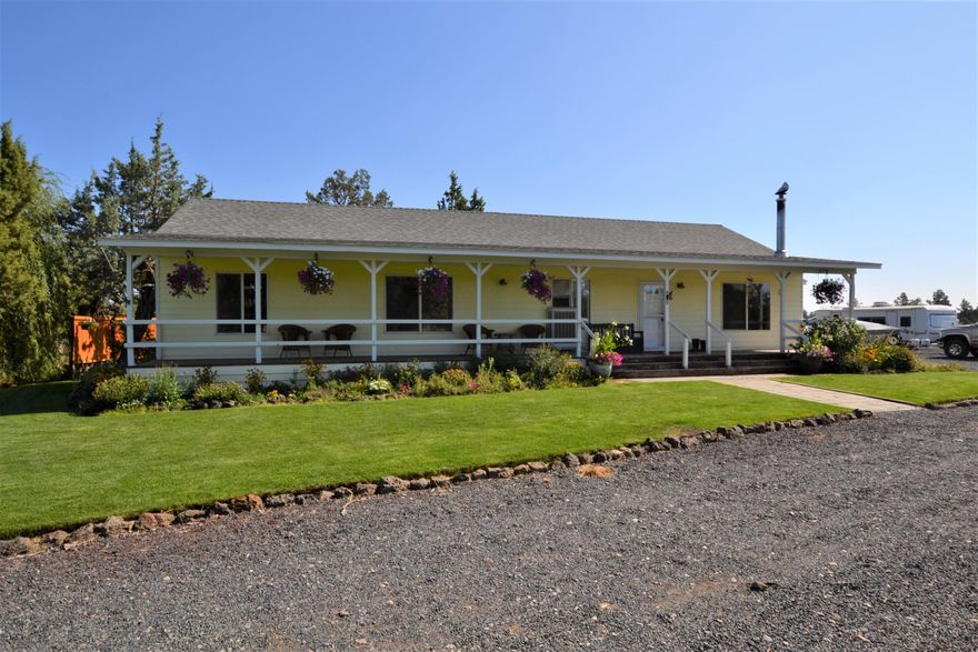 Your private oasis awaits! Just a short drive east of Bend, you will fall in love with this fully fenced 4.6 +/- acre property that has it all. The home is surrounded by lush green grass, mature trees and beautiful flowers. Inside you are welcomed into the great room with wood paneled vaulted ceilings with sky light for natural light, a cozy living room with wood stove and the open kitchen which features granite tile counters and tile floors throughout. There are 2 spacious guest bedrooms, 1 over size guest bath and the master which includes dual closets, a siting area, large master bath and french doors that lead to the back deck with hot tub. There is a 2-stall horse barn with tack room, bird coop, 1 grazing pasture and 2 riding areas already set up for your horses. A 25x30 greenhouse complete with drip irrigation for those veggies year-round. Dog run with insulated & heated doghouse & much more! New interior paint 2020, new roof 2017. This is country living at its finest!
