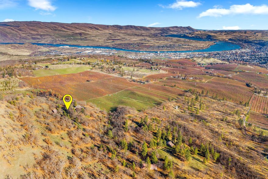 Located within the Columbia Gorge Scenic Area, this stunning property in The Dalles spans 9.13 acres with a panoramic view of the Columbia River Gorge, Washington hills and city lights of The Dalles. The 2,140 sq ft, single level home features 3 bedrooms, 2 bathrooms with hard surface countertops in the kitchen and ample cabinet storage. The dining and living room boast beautiful views of the river and Gorge and access an expansive deck. Meticulously maintained, this home showcases pride of ownership. This acreage property includes an attached 2-car garage with built-in cabinets for optimal storage as well as a detached 2-car garage along the paved, LED-lit driveway. Additionally, there is a private road that winds through a portion of the property with a large outbuilding. The septic tank was replaced in early 2024.