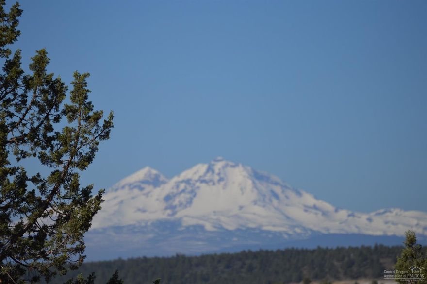 Beautiful Cascade views from this one-acre sloped building lot.  Underground power coming up property line on the west side of property.  Community water available at the street.  Needs septic feasibility.  You must walk this lot to experience its potential!  Community offers an 18-hole golf course, horse arena, disk golf, RV park, tennis courts and the best trout fishing in the Deschutes River, with community access.  A rural community where relationships are made!