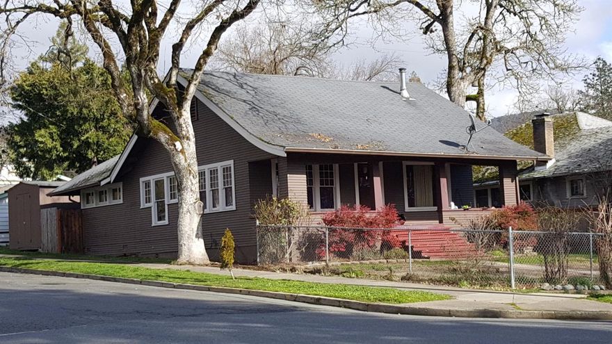 Beautiful Craftsman home located on a corner lot in NW Grants Pass! Walking distance to downtown and parks. Very large open living room with laminate hardwood flooring and dining area. Original Built ins for organization. Nice trim work and Full kitchen with enclosed Laundry room that leads out to your fully fenced yard with large utility shed. Central Heat and Air and country covered porch for those lazy, relaxing days. Lots of Street parking and sidewalks. Recent repairs have been done to the home to qualify for financing. Call to show today! All information deemed accurate but not guaranteed and subject to change at any time.