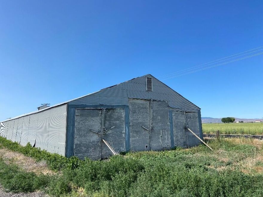 Storage/Cellar on County Rd 111 & next to Burlington Northern RR in Tulelake CA.  This building is 200' long & 46' wide with an asphalt floor, 3 phase power and is on land that is owned, (land is not leased from the RR).  3- swinging, double doors on each end.  Middle door is 13'6'' H & 14' W. Outside doors are 10'6'' H & 12' W.  Formerly used as potato storage, but can have other uses, such as hay, equipment storage & more.