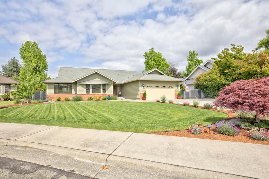 Beautifully landscaped and lovingly cared for 3b/ 2b 2,146 sf home with bonus shop! Home has open floor plan, nice hardwood floors, large living room with cathedral ceilings, a lovely fireplace in family room and dining room has built- in hutch. The primary has walk-in closet, walk-in shower & double sinks. Kitchen includes all stainless steel appliances and has generous counter and cabinet space with Corian countertops.  Spacious .38 acres gives you a great backyard, large patio area and a fenced garden area in the back. The 16x30 finished shop has a garage door, air conditioning unit and is wired for heat. Extra parking area with RV parking behind the gate or drive all the way back to the shop.  Recent upgrades include: brand new roof on shop, new landscaping, entire inside painted, lighting, smart thermostat and gas plumbed to range, washer & dryer and outside patio for BBQ.  This is truly a gem, don't miss out!!