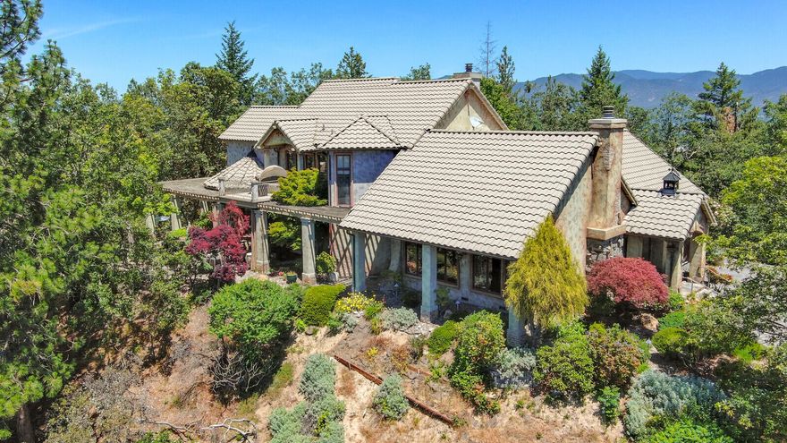 This exquisite estate property exceeds expectations& at a great price! Perched atop a knoll, the 14.44 acre parcel has unsurpassed panoramic views.  The quality of craftsmanship is extraordinary, with elegant interior & exterior finishes, open & spacious floorplan designed for views & gracious living. Custom features abound such as hardwood floors with cherry inlay, French doors with art glass to main level primary suite, luxury bathroom features including soaking tub, steam shower, double vanity, dressing room closet & laundry. Quality features include box beam ceilings, gas fireplaces in living & family rooms, clerestory ceiling above dining nook, gourmet kitchen with 6 burner Wolf Gas Cooktop, upscale Stainless double oven, custom farm sink, granite counters and handmade tile backsplash.  Copper gutters, tile roof, multiple courtyards with private nooks, all adorned by meticulous established landscape are just a few of the many amenities of this exceptional property.