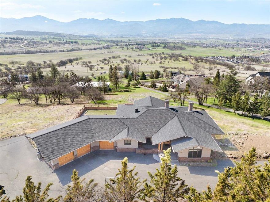 Exquisite 1-of-a-Kind Custom Built Home Located in the East Medford Hills on Aerial Heights, an Amazing Location, with Breathtaking Panoramic Views. Large private lot. Huge main floor primary suite, large gourmet style kitchen, excellent floor plan, large bedrooms, oversized 3-car garage, & RV parking with extra parking! Amazing front door opens to large living room with large view windows. With immaculate craftsmanship, the home showcases a beautiful hickory flooring, clear vertical grain fir cabinets, granite countertops, high-end plumbing & lighting fixtures, upgraded stainless steel appliances, custom cabinets, tile flooring, huge view decks, geothermal forced heat/air, generator, built-in sound system, 4 fireplaces, central vacuum system & more. Luxurious primary suite w/coffered ceilings, recessed lighting, Ultra air-jet tub, large tile shower, heated floors, & walk-in closet. This home is one of a kind! See ''Additional Information'' in attached Docs.