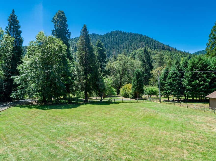 Lovely 1+ Acre Building Lot close in to Grants Pass. Former home was removed, but well, septic, access and fencing are all in place. RV parking with hookups. Can be a small horse property, quiet country home site, or would be a super addition to the adjacent river-front home also on the market, either as extended living or caretaker quarters. Lots of opportunity here--check out the possibilities. Lot cannot be sold prior to 4567 Averill. Buyer of 4567 Averill to have first right to purchase this home site.