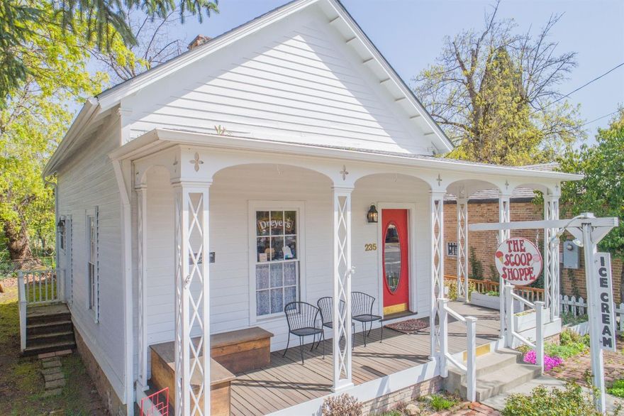 Unique Opportunity in downtown Jacksonville. Zoning allows for commercial or residential use. Currently set up for commercial use as an ice cream/candy shop, it could be easily converted back to residential or run a business in the front and live in the back. Seller has made over $30,000 in improvements including heating system, foundation and roof. A more inclusive list of improvements is attached. All of the Jacksonville charm with covered, wrap-around porch, white picket fence, hardwood floors and high ceilings. Business and inventory not included in sale but could be negotiated separately. Buyer to do due diligence with City of Jacksonville regarding possibilities.