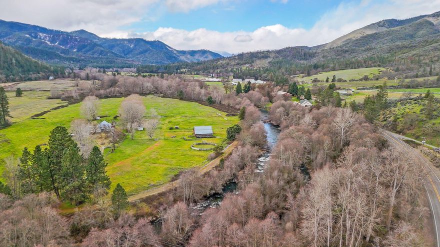 Welcome to your own private Applegate riverfront property, w/ close to 2,400 ft of river frontage, & a mix of over 58 EFU zoned acres of pastures & trees, w/ irrigation rights from the Applegate River. You will love the end of the road privacy this property provides, while also being less than 9 miles from historic Jacksonville. The 1-story home provides lovely views from every window, w/ wood floors & abundant natural light. Updates include fresh exterior & interior paint, new appliances, & a new water softener & water filtration system. Multiple outbuildings include a tack room, chicken coop, large barn & round pen for livestock. There is also a detached garage w/ separate room for storage or workshop.  This property encompasses the best of rural living; privacy, room for you & your animals & amazing river access!