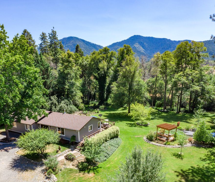 Riverfront, riverfront, riverfront! Beautifully remodeled 3bed/2bath home with 250' of Applegate riverfront. The tastefully crafted remodel is near complete and awaits your final touches. The front door opens to a great room with a vaulted ceiling, new windows, and new flooring. This expansive living area features a large propane fireplace, LED lighting, and sliding glass doors opening to the backyard. The gourmet kitchen with large island has granite countertops, stainless steel appliances and a propane stove. The open concept living area and kitchen has tons of light and easy access to a generous deck. Listen to the river while BBQing with family or entertaining on the porch. The beautifully manicured, park-like yard features two ponds, a garden area, gazebo, and multiple fruit trees. All this located in the beautiful Applegate Valley wine region, just a few doors down river from Red Lily Winery. Call the listing agent to schedule a showing today!