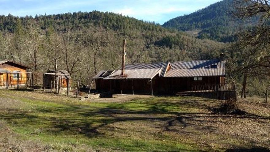 Here's your little slice of heaven!! Log exterior home with metal roof. Living room features stone hearth, vaulted ceiling with fan, rustic wood siding throughout. TLC needed, Kitchen rehab needed. Bring your cash and enjoy your paradise.